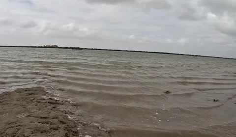 Rippling Brown Water at Empty Beach on Stormy Day Stock Footage 341322531