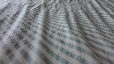 Rippling fabric creates calming patterns on bed linens Stock Footage 321327001
