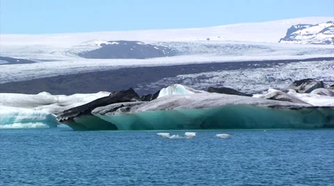 Rippling lake water surface in front of icebergs and large glacier Stock Footage 37967512