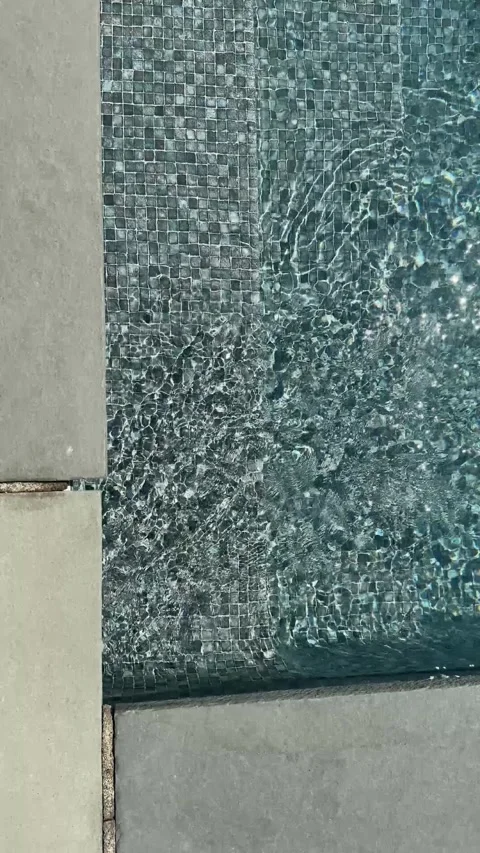 Rippling Pool Water Over Mosaic Tile at Stone Edge Vertical Stock-Footage 339071061