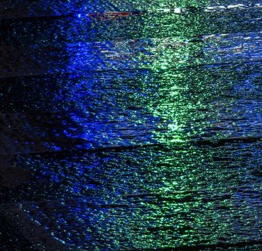Rippling reflections dance under a midnight sky, creating a mesmerizing vis.. Stock Photos