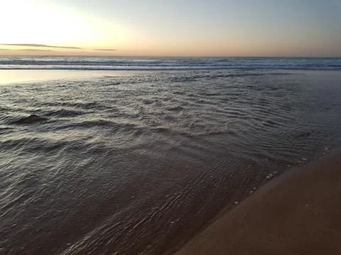 Rippling small waves at the beach. Stock Photos