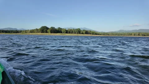 Rippling water surface and waves created by moving boat on large lake Stock Footage 340253999