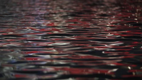 Rippling water surface with red light reflection 스톡 동영상 124624713