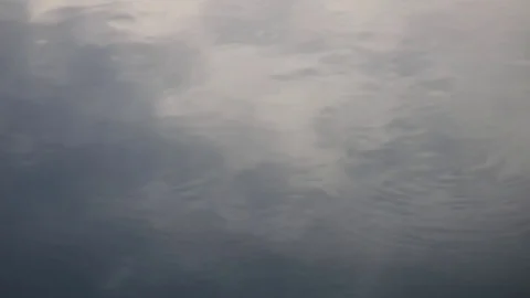 Rippling water surface reflecting the clouds in the evening light Stock Footage 93782515