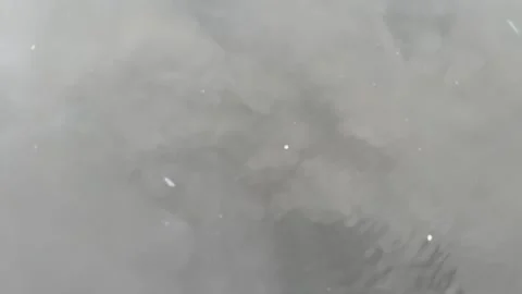 Rippling water surface with visible pollution and floating debris Stock Footage 314708536