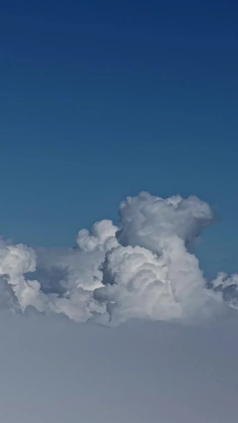 Rise above the cloud so high, peaceful flight in a bright blue sky Stock Footage 336737089