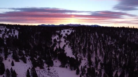 Rise over hill to mountain range at sunset Stock Footage 310572043