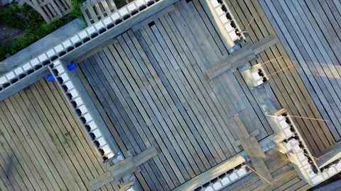 Rise with rotation over the construction site of a country house. HEAD OVER SHOT Stock Footage