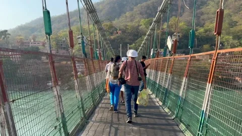 Rishikesh, India - April 1, 2025. Ram Jhula bridge above the Ganga river Stock Footage 315876965
