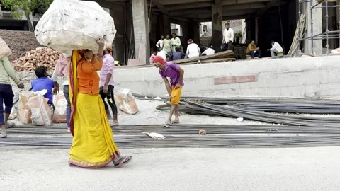 Rishikesh, India - April 7, 2025. Indian woman carrying load on head Stock Footage 315877054