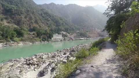 Rishikesh, India establishing shot. Trees, the Ganges River, and ashrams. Stock Footage 83469699