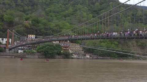 Rishikesh’s Bridge Amidst the Himalayan Backdrop Stock Footage 313564442