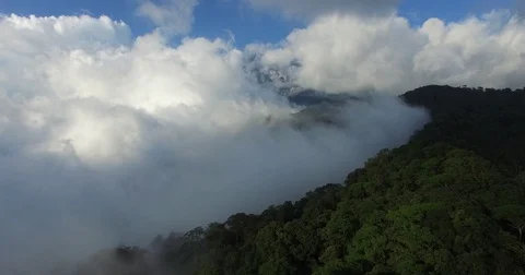 Rising above clouds and mountain, aerial pedestal shot, South East Asia Stock Footage 81260443