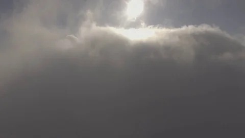 Rising above the clouds overlooking a formation of steam from a factory exhaust Stock Footage 72904715