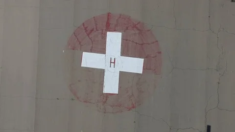 Rising above a helipad in a near empty parking lot Stock Footage 88568367