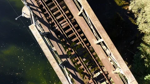 Rising above old rustic railway bridge over river. Stock Footage 118188383