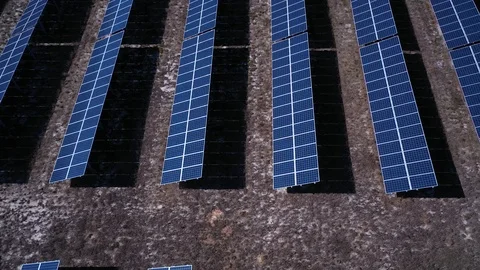 Rising above rows of solar panels in a solar farm Stock Footage 119705918