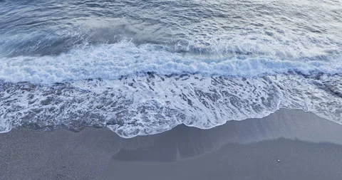 Rising above the waves over the sandy shore of the beach Stock Footage 262488458