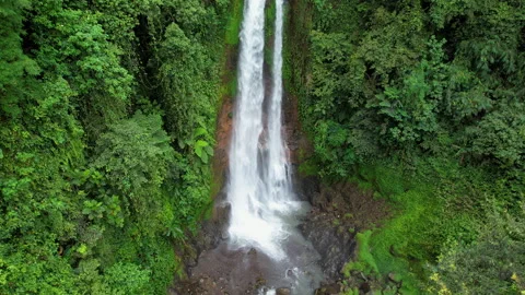 Rising up aerial footage of Gitgit waterfall on cloudy day. Bali, Indonesia. Stock Footage 285991535