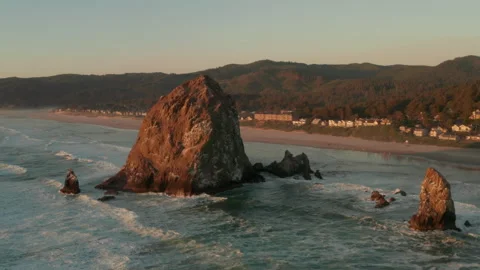 Rising aerial shot of Haystack rock and Cannon beach Stock Footage 250250974