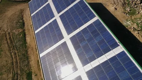 Rising aerial tilts to view large array of solar panels in sunshine Video stock 328987007