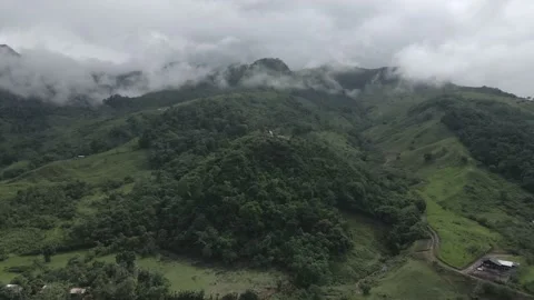 Rising aerial of tiny religious shrine in lush overcast valley in Peru 動画素材 170915976
