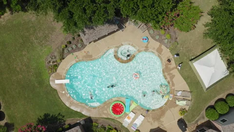 Rising aerial view looking down at swimming pool in residential back yard, Texas Видео 248078361