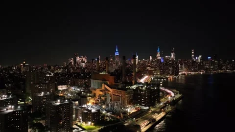 Rising and Flying Forward Over FDR Drive Toward Empire State at Night Stock Footage 345292744