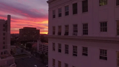Rising up an apartment building at sunset Stock Footage