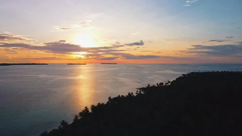 Rising Backward Drone Shot at Sunset Over Island Stock Footage 323870376