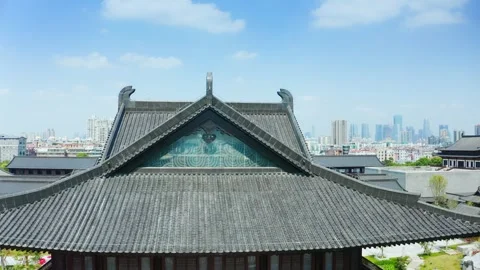 Rising beyond a tiled gable at Guangzhou Cultural Center in China Stock-Footage 346029337