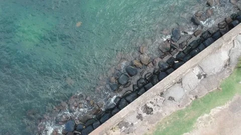 Rising birds-eye view spin above Nawiliwili Bay sea wall Stock Footage 155457454
