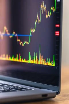 Rising candlestick chart on laptop screen. Trading data and financial marke.. Stock Photos