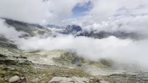 Rising clouds over alpine lakes and peaks - Swiss Alps panorama Stock-Footage 328405365
