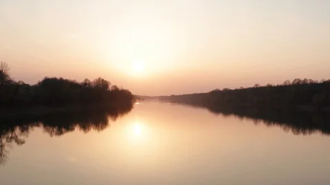Rising the drone above river at Sunset time. Filmed in 4k. Stock Footage 127570514