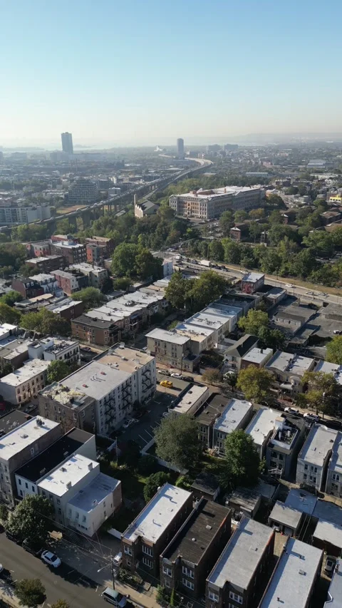 Rising drone angle showing Jersey City’s compact housing rows, building Stock Footage 321882878