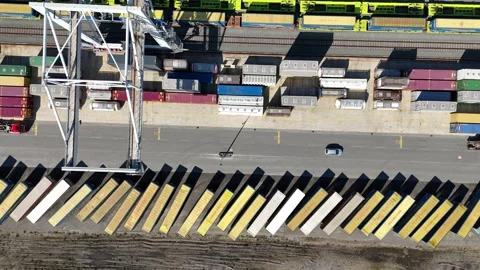 Rising drone over stacked containers and moving crane Video stock 331896625