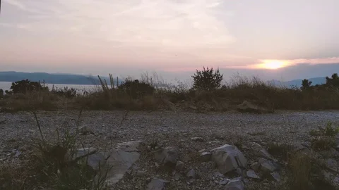 Rising drone view over a hill with a village and a sea behind Stock Footage 112333419
