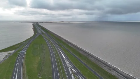 Rising drone view over interchange and distant wind turbines Stock Footage 331828720