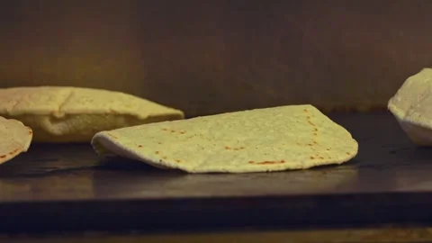Rising Flatbreads: Close-Up of Fresh Flatbreads Puffing Perfectly on the Grill Stock Footage 288693425
