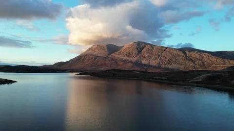 Rising forward drone approach over Loch Stack toward Arkle Stock Footage 323367658