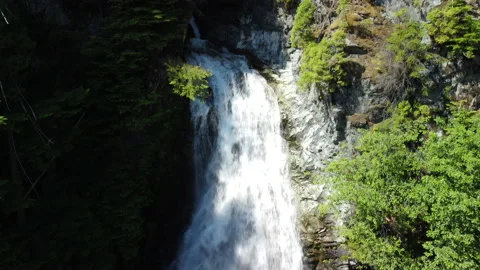 A rising high angle of a waterfall in sunlight Stock Footage 163180607