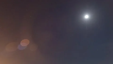 Rising moon light ray n star with bokeh lens flare on dark night sky TimeLapse Stock Footage 180450823