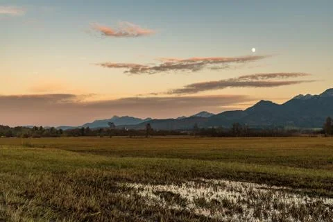 The rising moond with a puddle in the foreground Stock Photos