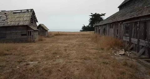 Rising from an old barn to the ocean Stock Footage