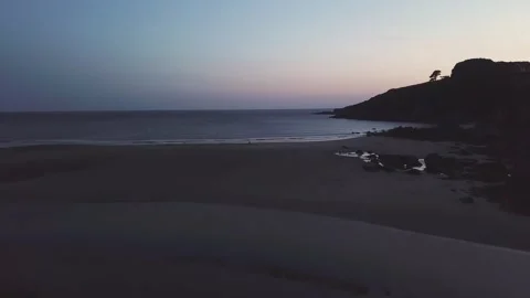 Rising up over beach in devon uk, after sunset 4k Stock Footage 320946429