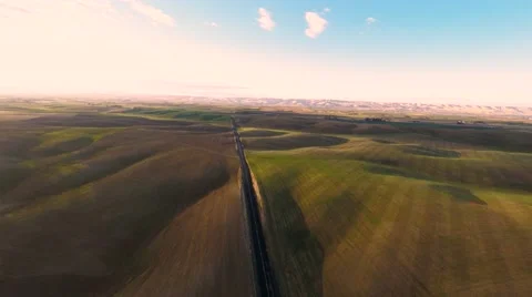 Rising up over the fields with asphalt road Stock Footage 43617902