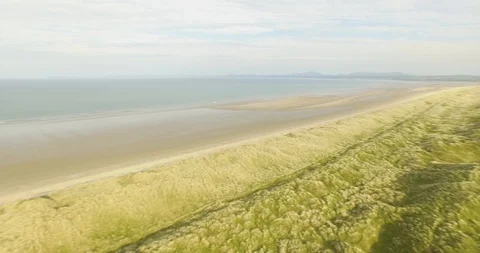 Rising over Harlech Beach and sand dunes Stock Footage 90056645