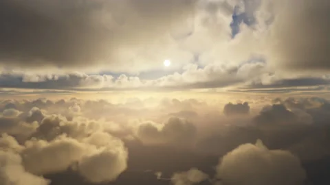Rising over layers of clouds with the sun in the horizon Stock Footage 155658889